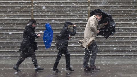 People walk as snow falls at the U.S. Capitol in Washington on Wednesday, March 6.