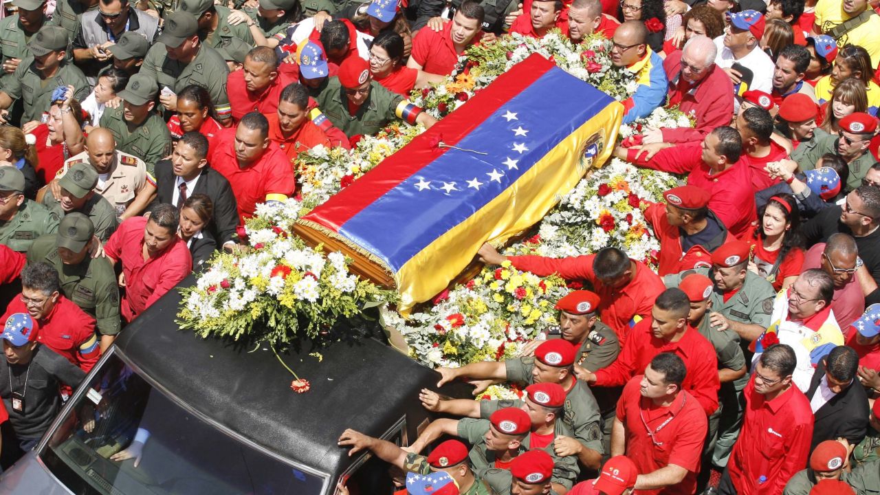 Members of the military escort Chavez's casket down the streets of Caracas on March 6.