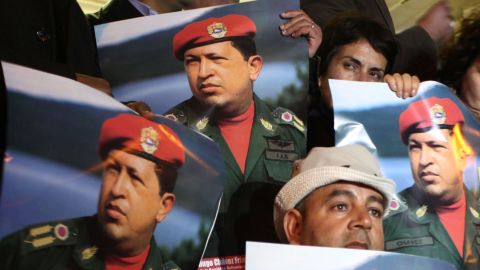 Palestinians hold portraits of Chavez during a rally in front of the Venezuelan Embassy, in the West Bank city of Ramallah, on March 6.