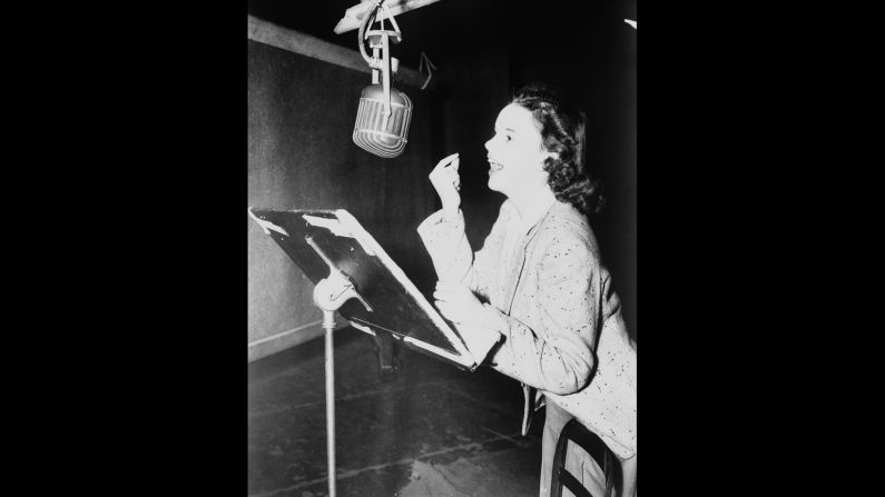 Judy Garland records a vocal track on the MGM orchestra stage.
