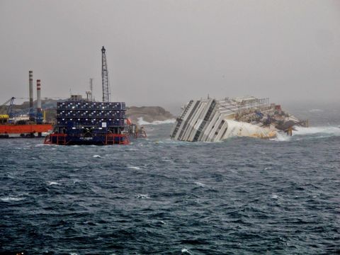 The five story-high block of floating flats, pictured left, houses the divers working around the clock on the salvage operation.