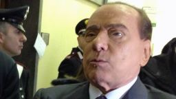 Former Italian Prime Minister Silvio Berlusconi reacts in a corridor of Milan's tribunal during a hearing of the Mediaset trial on March 1, 2013.