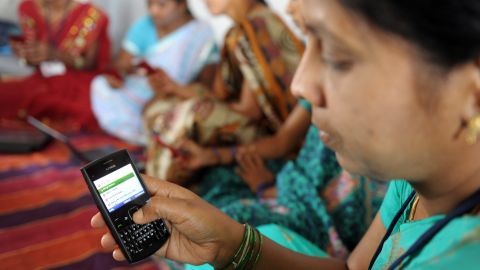 Indian villagers use mobile phones in Bibinagar village outside Hyderabad on March 7, the eve of International Women's Day.