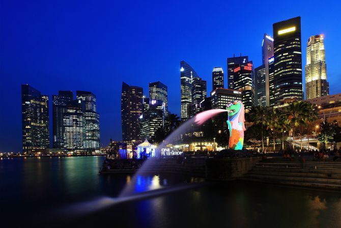 Singapore has its Global Investor Program where applicants can invest $2 million for permanent residency. Citizenship is possible after two years.  Here, a view of the Merlion and the central business district skyline.