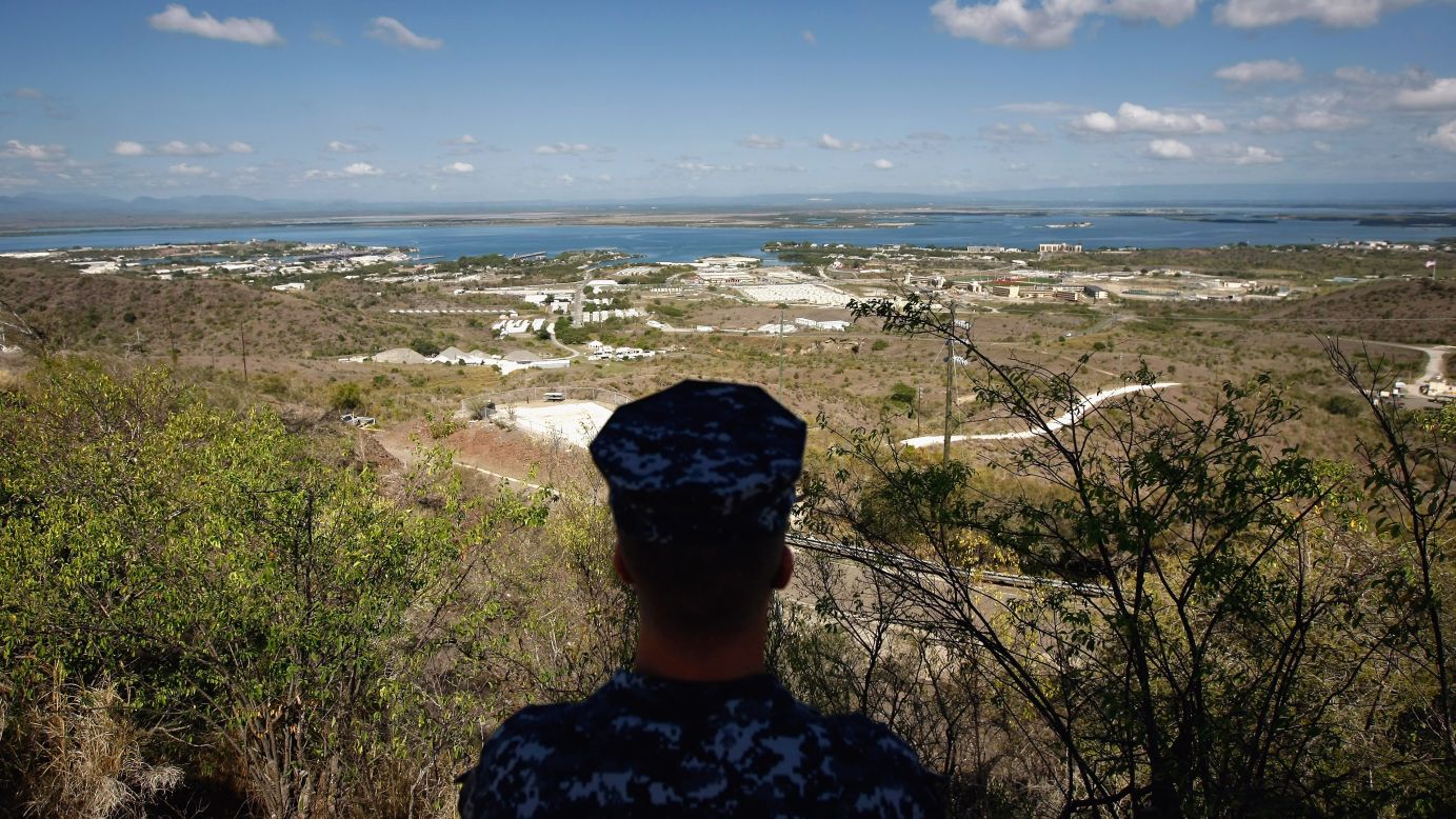 A Navy sailor surveys the base in October 2009. In December 2013, Congress <a href="http://politicalticker.blogs.cnn.com/2013/12/26/obama-signs-budget-defense-bills-in-hawaii/" target="_blank">passed a defense-spending bill</a> that makes it easier to transfer detainees out of the facility.