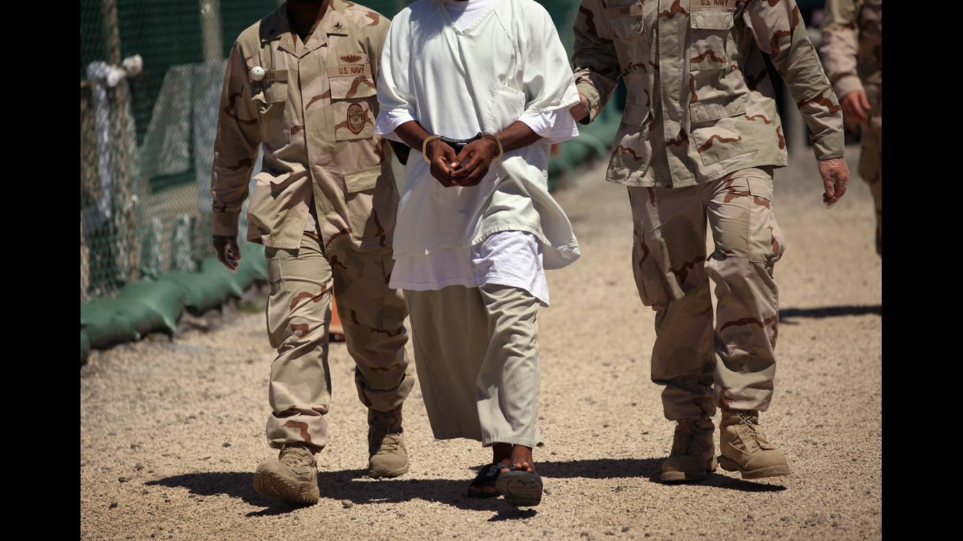 US military guards move a detainee inside the detention center in September 2010. At its peak, the detainee population exceeded 750 men.