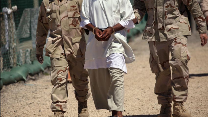 U.S. military guards move a detainee inside the detention center on September 16, 2010.