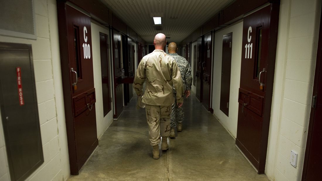 Members of the military walk the hallway of Cell Block C in the Camp 5 detention facility in January 2012. 