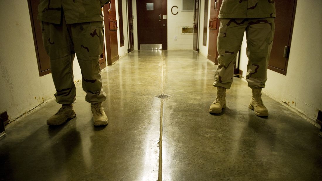Members of the military move down the hallway of Cell Block C in the Camp 5 detention facility in January 2012.