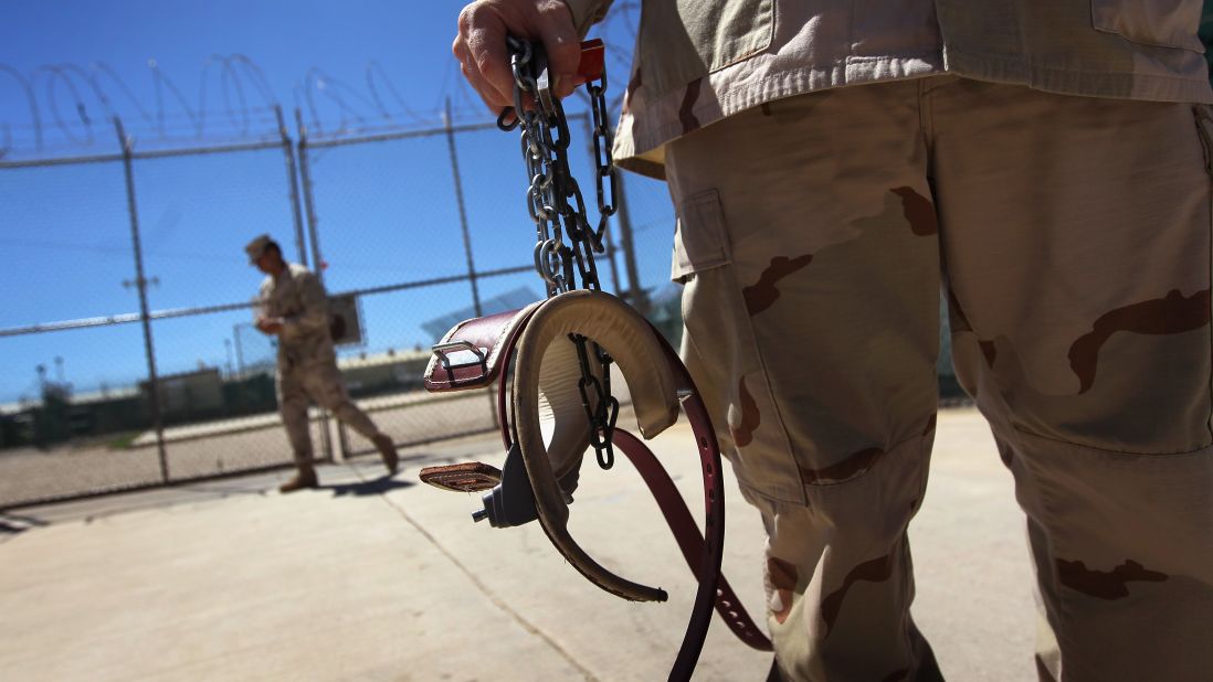 A guard holds shackles before preparing to move a detainee in September 2010.