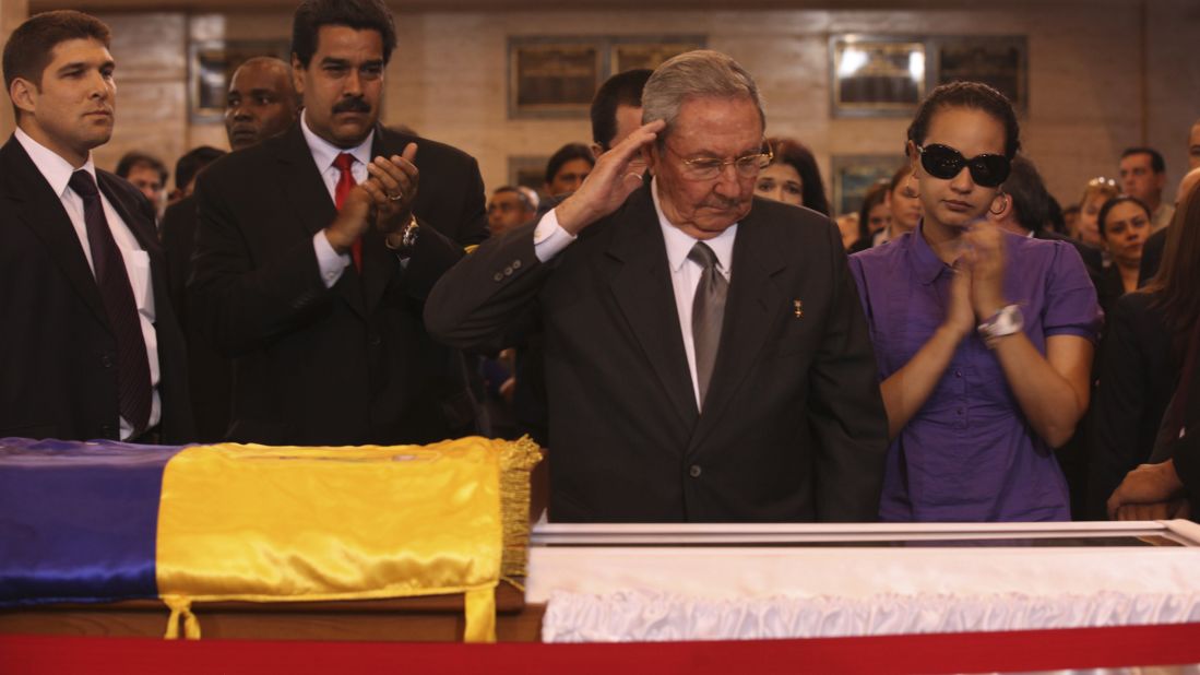 Cuban President Raul Castro salutes Chavez's body as he visits the wake with Chavez's daughter, Rosa Virginia, right, and Venezuela's Vice President Nicolas Maduro on Thursday, March 7.