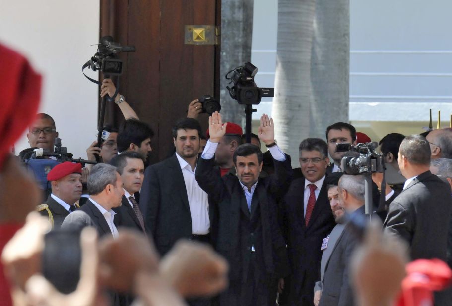 Iranian President Mahmoud Ahmadinejad, center, waves alongside Venezuelan Minister of Foreign Affairs Elias Jaua outside of the funeral of the President Hugo Chavez in Caracas, on March 8.