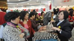 Women shop at a woman's clothes store in Shanghai with discounts for International Women's Day on March 8, 2013. International Women's Day in China is celebrated with various events including discount shopping for women at malls in cities around China.