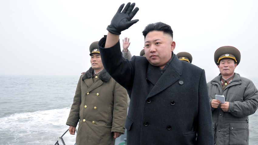 North Korean leader Kim Jong Un (center) waves to soldiers from a boat as he inspects the Mu Islet Hero Defence Detachment near South Korea's Taeyonphyong Island.