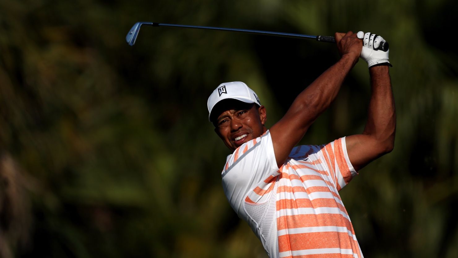 Tiger Woods makes another confident shot during his seven-under-par 65 at Doral's Blue Monster course in Florida.