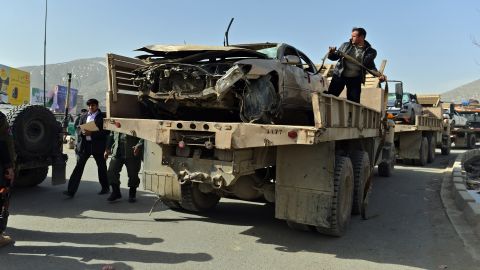 Afghanistan National Army soldiers remove a destroyed car at the site of a suicide attack next to the Defense Ministry in Kabul.