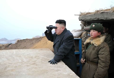 Kim uses a pair of binoculars to look south from the Jangjae Islet Defense Detachment, near South Korea's Taeyonphyong Island, in March 2013.
