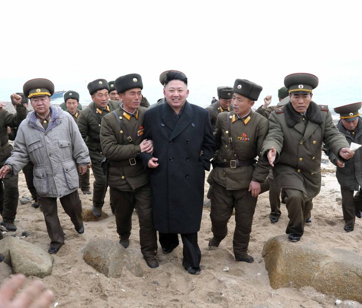 Kim is surrounded by soldiers during a visit to the Mu Islet Hero Defense Detachment, also near Taeyonphyong Island, in March 2013.