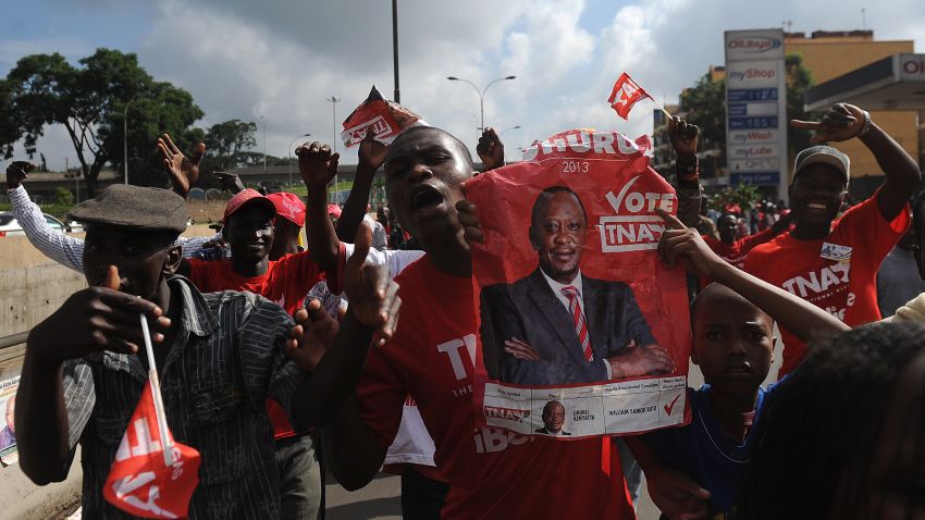 Supporters of Uhuru Kenyatta hold his poster as they celebrate his victory on March 9, 2013 in Nairobi.