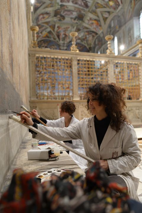 Two painters prepare the walls of the Sistine Chapel on Friday, March 8 in advance of the papal conclave.