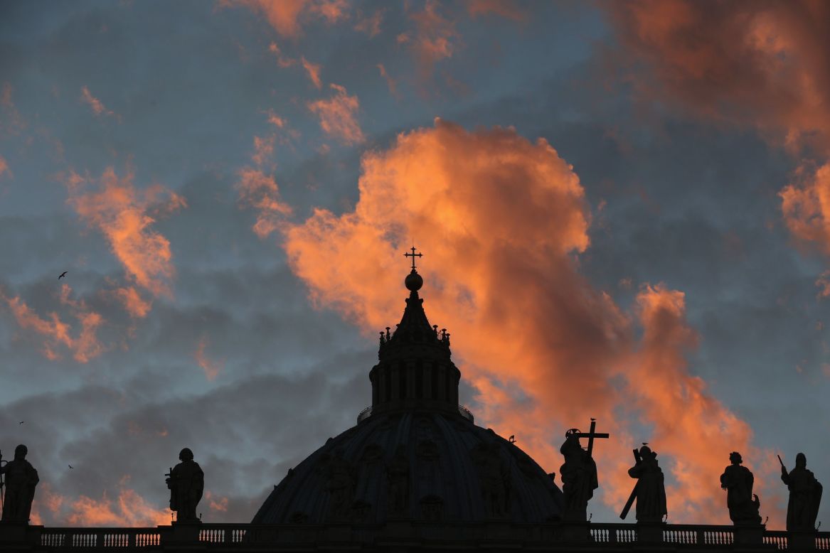 The sun sets over St Peter's Basilica as cardinals prepare to vote for a new pope on March 9.