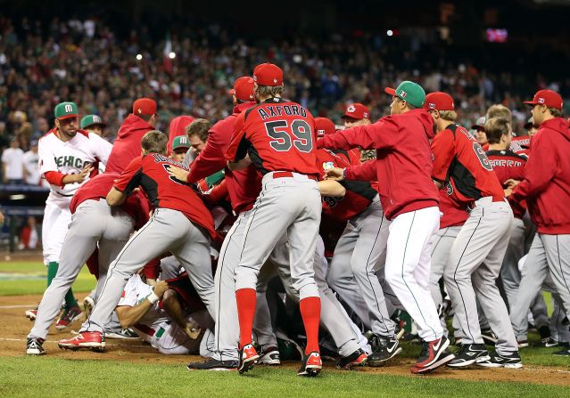 Players and coaches from Mexico and Canada converge in an on-field brawl during the World Baseball Classic on March 9.