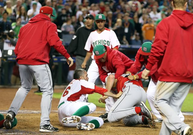 Pitcher Oliver Perez (left) and coaches of Mexico attempt to subdue Scott Mathieson of Canada during a brawl at the World Baseball Classic on March 9.
