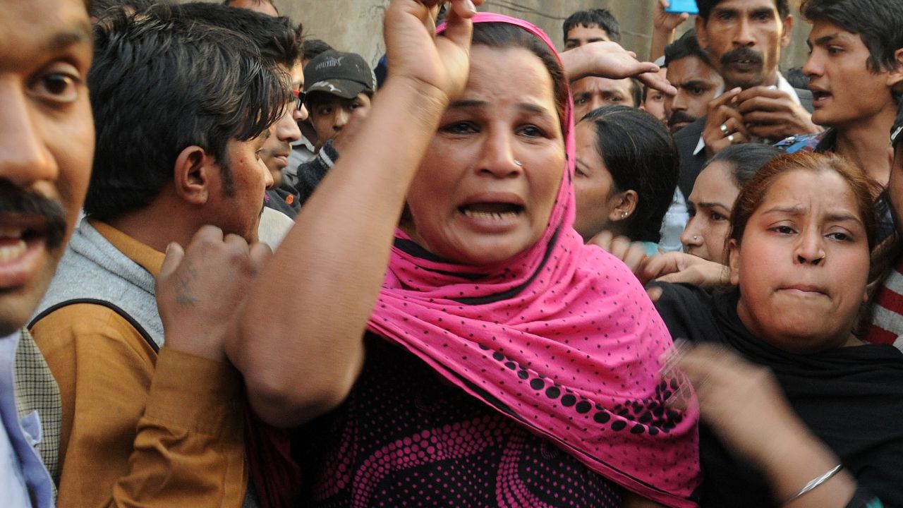 Pakistani Christians react after Muslim demonstrators destroyed the homes of members of the Christian community.