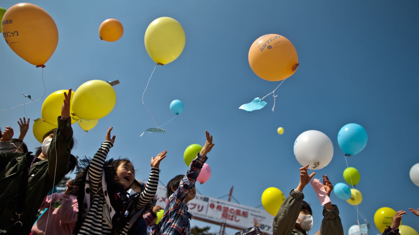 Children in Minamisoma, Japan, float balloons while paying respects on Sunday, March 10, a day before the second anniversary of the disaster.