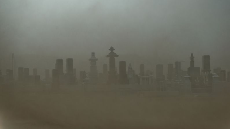 A cemetery in Odaka has low visibility in heavy wind on Sunday. The city became a nuclear ghost town after the 2011 disaster.