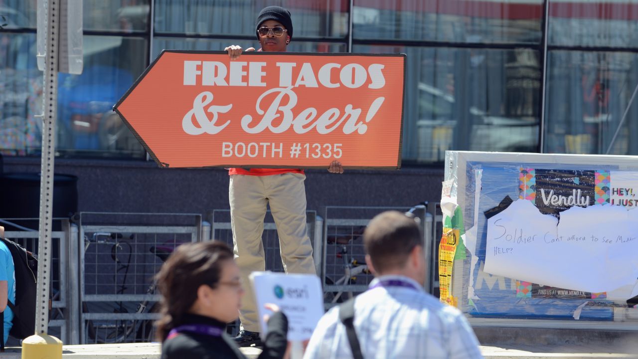 A man advertises free tacos and beer during SXSW on March 10.