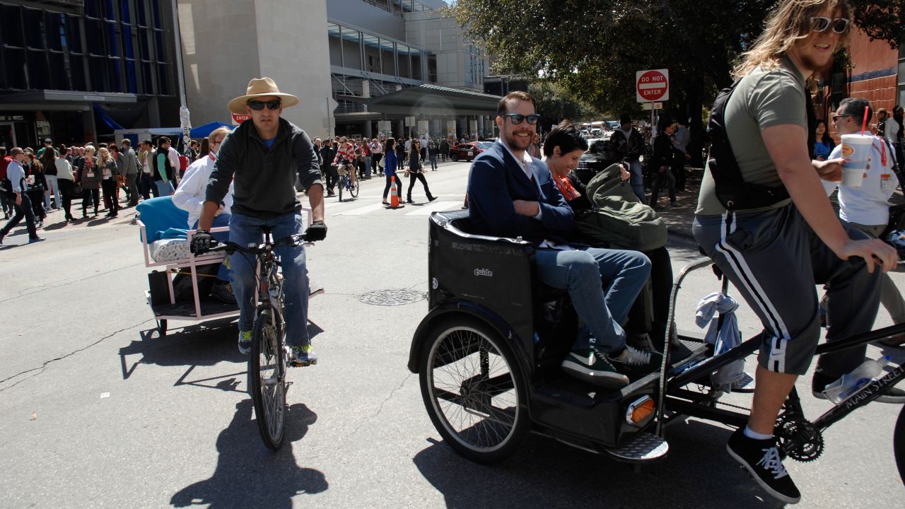 SXSW attendees get a ride through the streets of Austin on March 10.