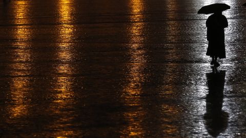 A nun walks through the rain under an umbrella in St. Peter's Square at the Vatican on Sunday, March 10.