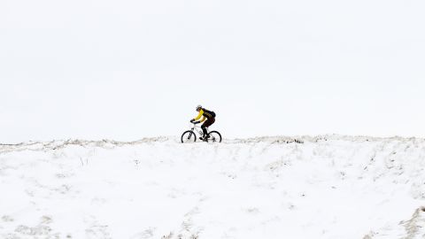 A cyclist makes his way along a snowy track near Ladmanlow, United Kingdom, on March 10 as a return of freezing temperatures and snow delay springtime weather for Great Britain.