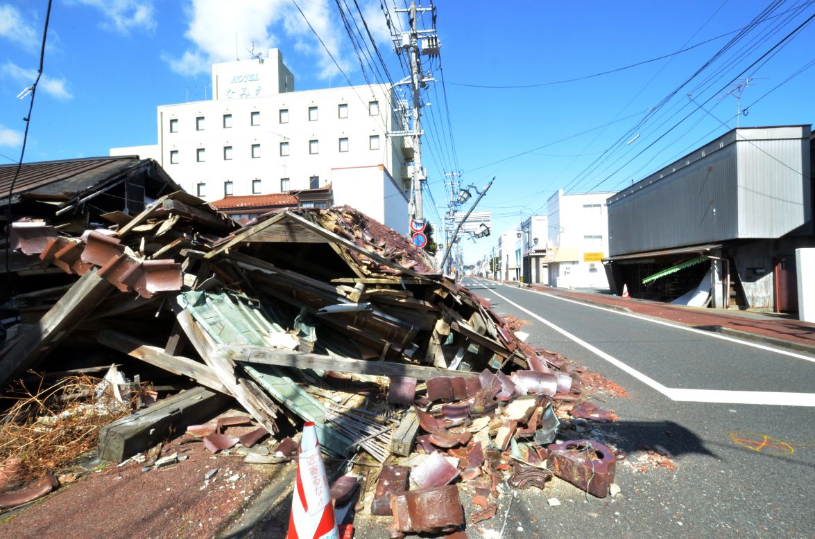 Collapsed houses still line on a street in Namie on Monday.