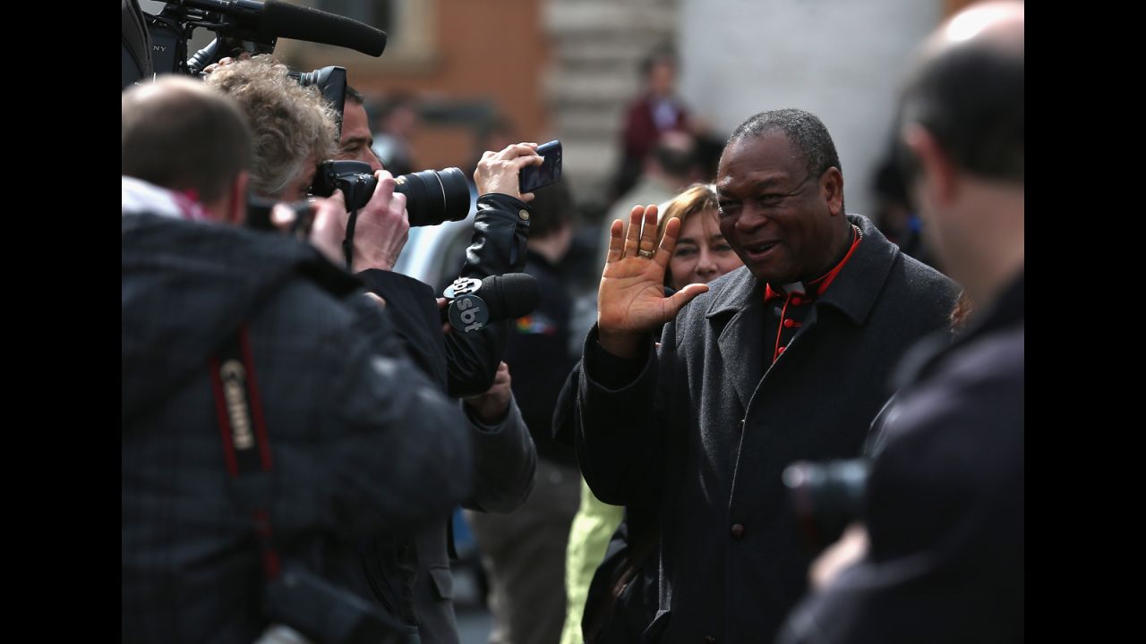 Nigerian Cardinal John Onaiyekan is surrounded by media on March 11 as he leaves the final congregation before cardinals enter the conclave to vote for a new pope.
