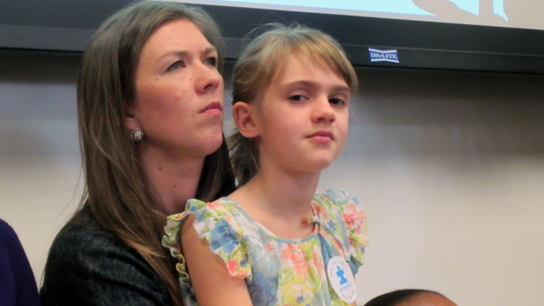 Ava Bullard, 8, sits with her mom, Anna, at a hearing of the insurance committee of the Georgia State Senate.