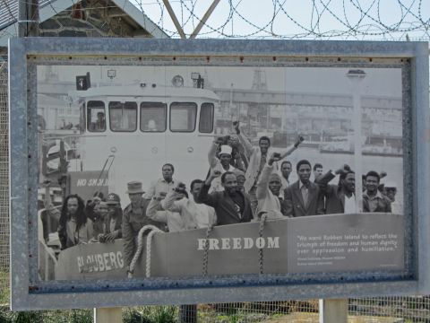 Photograph of former Robben Island prisoners. Ahmed Kathrada, senior ANC leader and close friend of Nelson Mandela during their time in prison, said on their release, "We want Robben Island to reflect the triumph of freedom and human dignity over oppression and humiliation."