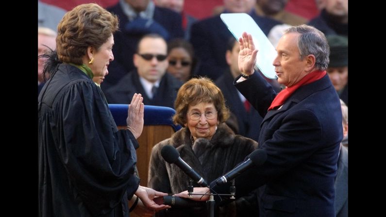 Bloomberg is sworn in by New York Judge Judith S. Kaye as Bloomberg's mother, Charlotte Bloomberg, holds the Bible  on the steps of City Hall in January 2002.