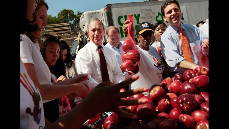 Bloomberg joins volunteers to bag apples for poor families as part of a Mandela Day event in July 2009. Mandela Day is a celebration of Nelson Mandela's life and legacy. It encourages good works and volunteerism around the world.