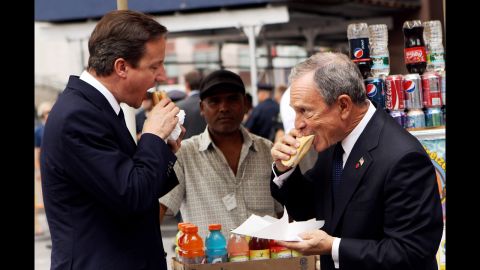 British Prime Minister David Cameron eats a hot dog with Bloomberg outside New York's Penn Station on July 21, 2010. Cameron met with Bloomberg and U.N. Secretary General Ban Ki-moon during his visit to New York. 