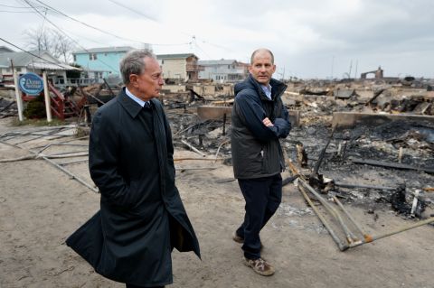 In October 2012, Bloomberg views damage in the Breezy Point area of Queens, where a fire destroyed about 80 homes as a result of Hurricane Sandy. Sandy killed at least 113 people in the United States and heavily damaged New York's infrastructure.