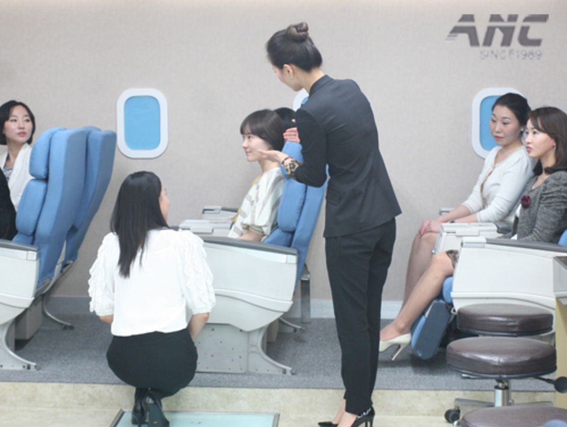At ANC flight attendant academy in Seoul, students practice role-playing in a classroom simuating a plane. 