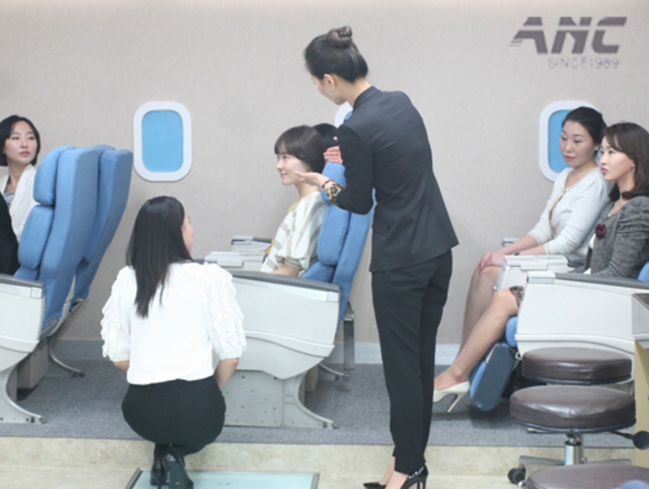 At the ANC flight attendant academy in Seoul, South Korea, students role play in a classroom simulating a plane. 