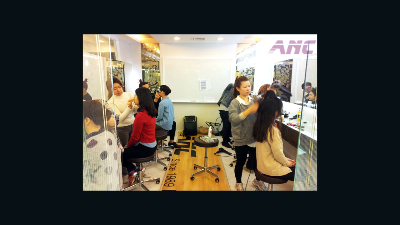 Students at Seoul flight attendant academies practice getting the right look.