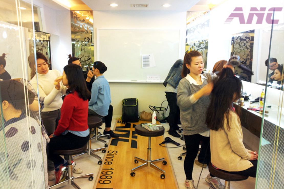 Students at Seoul flight attendant academies practice getting the right look.