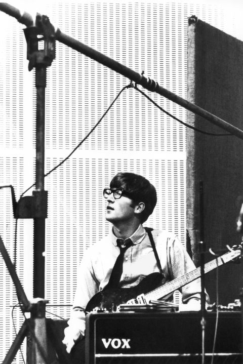John Lennon works in the studio wearing the glasses that at the stage he rarely wore in public.