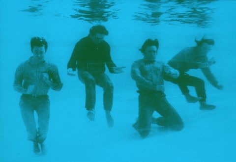 The Beatles pose fully-dressed underwater in the pool of the Nassau Beach Hotel in the Bahamas where they were filming their comedy movie "Help!" Freeman was with them on set.
