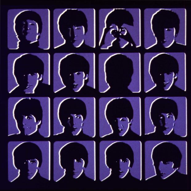 The original UK cover of the Beatle's third album, "A Hard Day's Night," in blue. Four rows of four head shots of each Beatle with different facial expressions are set up as frames from a movie.