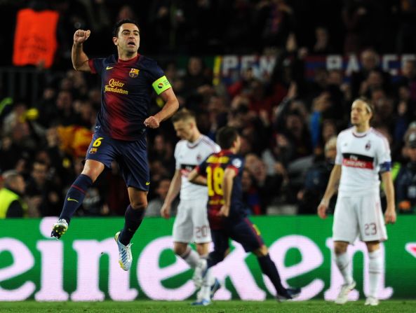 Xavi, captaining the side in place of Carles Puyol, jumps for joy after Messi's early strike. Barcelona looked a completely different side to that which lost at San Siro three weeks ago as it  piled the pressure on Milan.